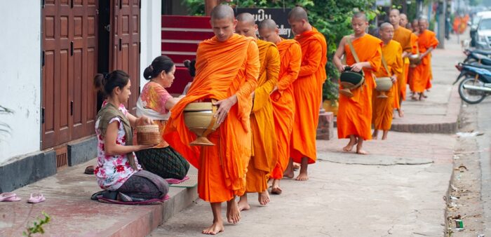 Early Morning Alms Giving to the Monks in Luang Prabang, Laos. Copyright © 2022 Terence Carter / Grantourismo. All Rights Reserved.