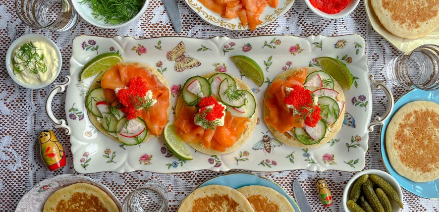 Smoked Trout Blini with Caviar, Crème Fraîche, Cucumber, Radish and Dill. Copyright © 2024 Terence Carter / Grantourismo. All Rights Reserved.