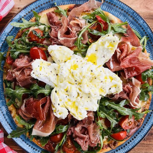 Burrata Pizza Recipe with Prosciutto, Rucola and Cherry Tomatoes. Copyright Grantourismo 2025 Terence Carter Lara Dunston